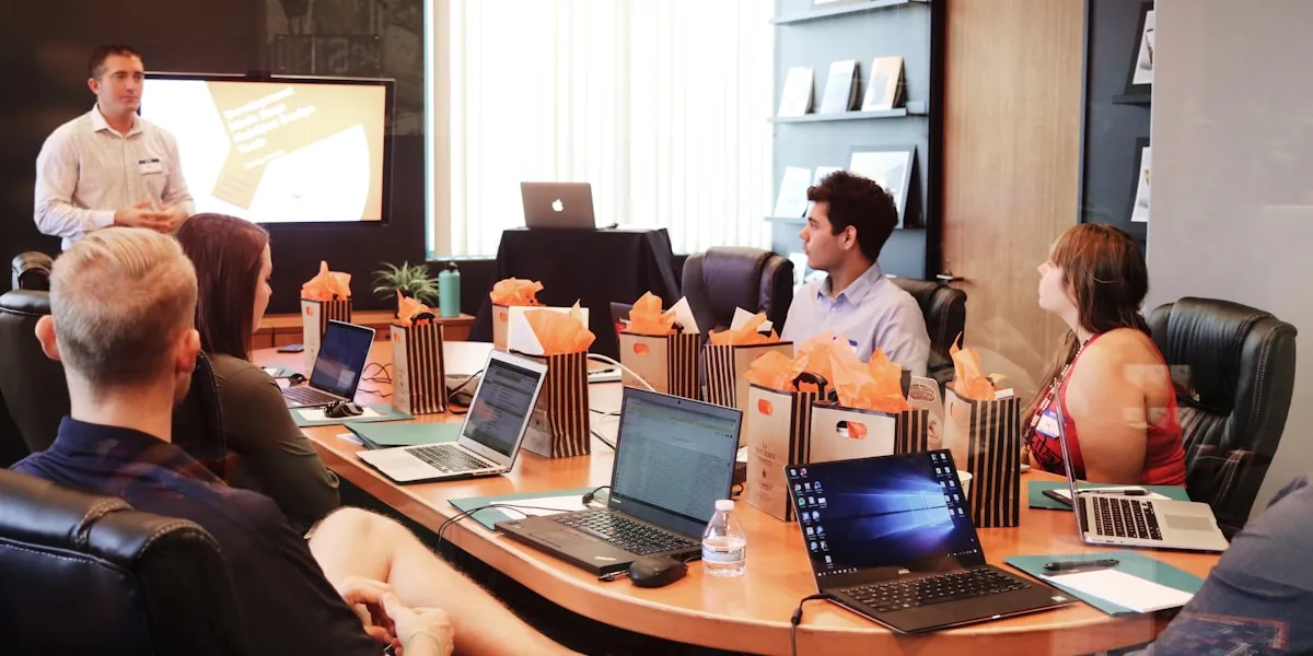 Besprechung an einem Konferenztisch mit Laptops
